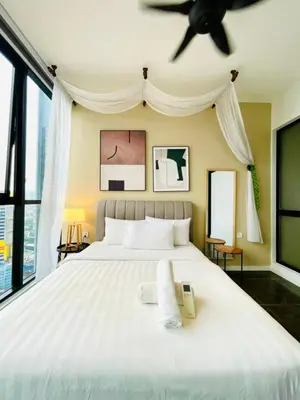 a bedroom with a white bed with a ceiling fan at KLCC Scarletz Residence Near By KL in Kuala Lumpur