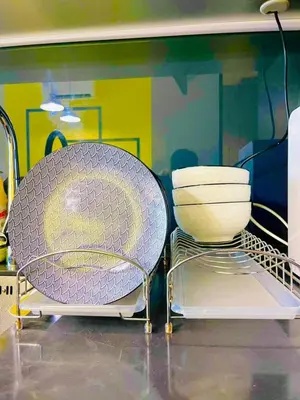 two plates and a bowl sitting on top of a shelf at KLCC Scarletz Residence Near By KL in Kuala Lumpur