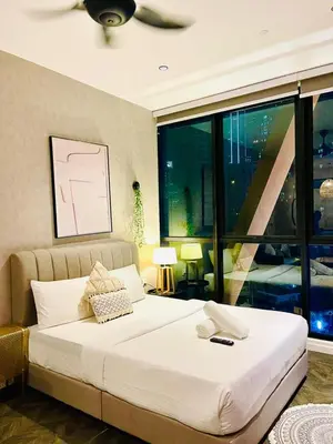 a large bed in a room with a large window at KLCC Scarletz Residence Near By KL in Kuala Lumpur