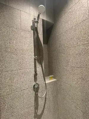 a shower with a shower head in a bathroom at KLCC Scarletz Residence Near By KL in Kuala Lumpur