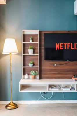 a living room with a television on a white shelf at Bintang Fairlane near Pavillion Bukit Bintang in Kuala Lumpur