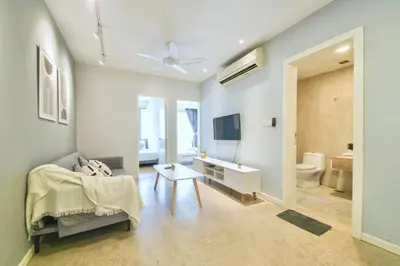 a living room with a couch and a tv and a bathroom at Bintang Fairlane near Pavillion Bukit Bintang in Kuala Lumpur