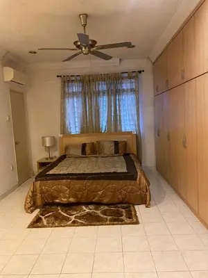 a bedroom with a bed and a ceiling fan at Urban bloom stays in Kuala Lumpur