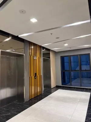 a hallway with elevators and glass doors in a building at klcc 2 bedroom trion in Kuala Lumpur