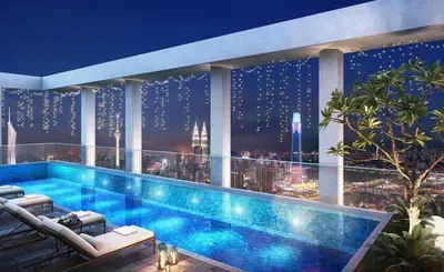 a swimming pool on top of a building with a city skyline at klcc 2 bedroom trion in Kuala Lumpur