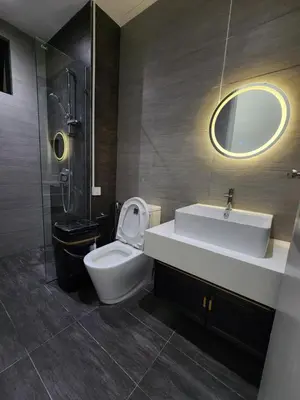 a bathroom with a sink and a toilet and a mirror at klcc 2 bedroom trion in Kuala Lumpur