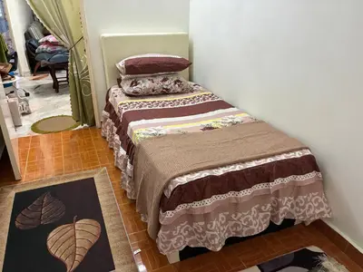a small bedroom with a bed in a room at Baiduri Homestay in Kuala Lumpur