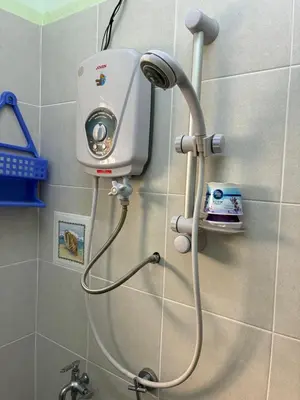 a shower in a bathroom with a water hose at Baiduri Homestay in Kuala Lumpur
