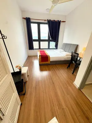 a bedroom with a bed and a desk and a window at M Vertica Homestay in Kuala Lumpur