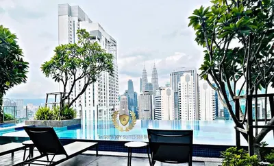 a balcony with chairs and a view of a city at The Majestic Gen Luxury Suites KLCC in Kuala Lumpur