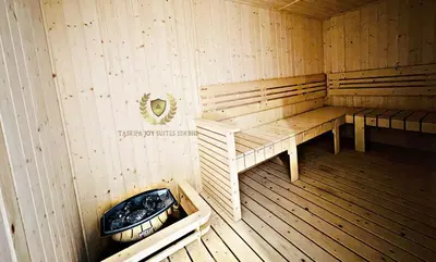 a sauna with a bench and a tub in it at The Majestic Gen Luxury Suites KLCC in Kuala Lumpur
