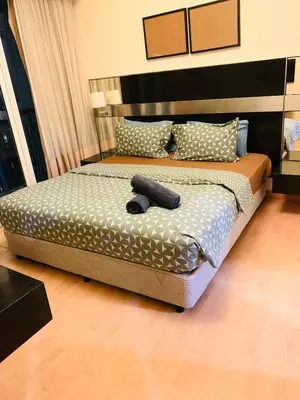 a bedroom with a bed with a remote control on it at Anhome Seri bukit Ceylon in Kuala Lumpur