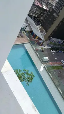 an overhead view of a blue pool with a plant at Quill Residence - Blissful Urban Condo by Azmila in Kuala Lumpur