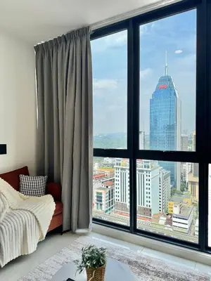 a room with a large window with a view of a city at Majestic Residence Suite KLCC in Kuala Lumpur