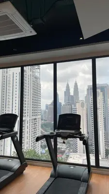 a gym with a view of a city skyline at Majestic Residence Suite KLCC in Kuala Lumpur