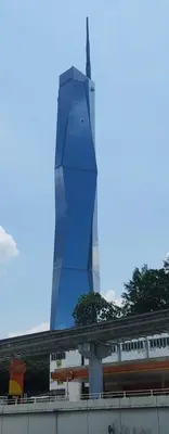 a tall blue building with a train in front of it at I LUX I-Hotel Kuala Lumpur in Kuala Lumpur