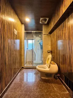 a bathroom with a toilet and a glass shower at Triple B Hotel in Kuala Lumpur