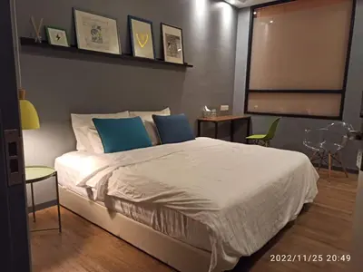 a bedroom with a large white bed with blue pillows at Penthouse-Bukit Bintang in Kuala Lumpur