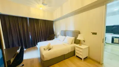 a hotel room with a bed and a window at Star Residence Suites KLCC Sky pools in Kuala Lumpur