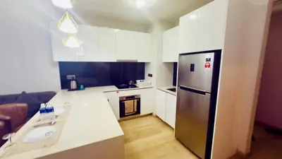 a small kitchen with a refrigerator and a sink at Star Residence Suites KLCC Sky pools in Kuala Lumpur