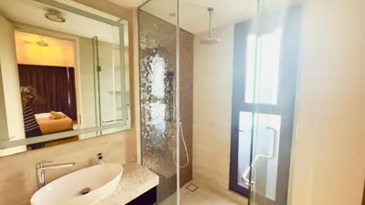 a bathroom with a sink and a glass shower at Star Residence Suites KLCC Sky pools in Kuala Lumpur