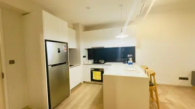 a kitchen with a refrigerator and a counter top at Star Residence Suites KLCC Sky pools in Kuala Lumpur