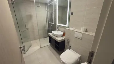 a bathroom with a shower and a sink and a toilet at Star Residence Suites KLCC Sky pools in Kuala Lumpur