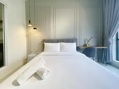 a bedroom with a large white bed and a desk at Arte Mont Kiara By Comfortcorner in Kuala Lumpur
