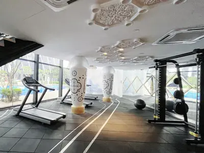 a gym with exercise equipment in a room with windows at Arte Mont Kiara By Comfortcorner in Kuala Lumpur