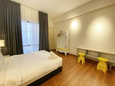 a bedroom with a bed and a table and a mirror at Arte Mont Kiara By Comfortcorner in Kuala Lumpur