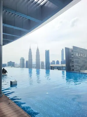 a swimming pool on the roof of a building with a city at Eaton Residence KLCC Kuala Lumpur in Kuala Lumpur