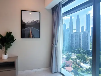 a room with a window with a view of a city at Eaton Residence KLCC Kuala Lumpur in Kuala Lumpur