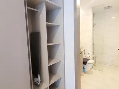 a bathroom with a toilet and a television in a closet at Eaton Residence KLCC Kuala Lumpur in Kuala Lumpur