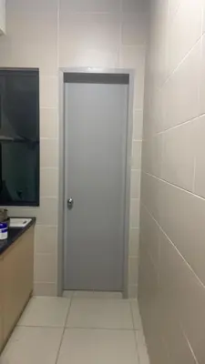 a white door in a bathroom with a tiled wall at The nest apartment in Kuala Lumpur