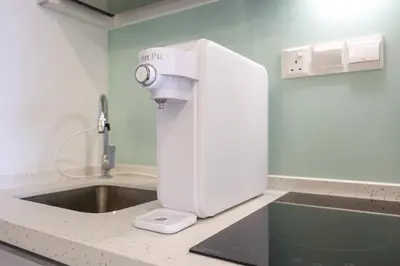 a sewing machine sitting on a counter next to a sink at Riveria City Home Plus in Kuala Lumpur