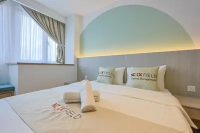 a bedroom with a large bed with towels on it at Riveria City Home Plus in Kuala Lumpur