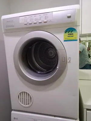 a white washing machine with its door open at Vortex Suites KLCC by Comfy Stay in Kuala Lumpur