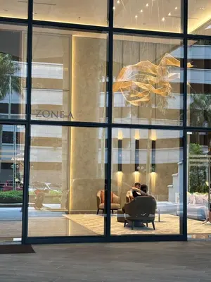 a person sitting in a chair in front of a building at Pavilion Ceylon Hill Luxury suit Bukit Bintang by cupidhome in Kuala Lumpur