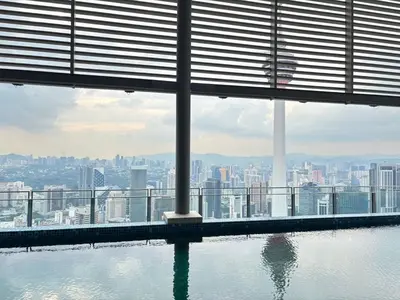 a swimming pool in a building with a view of a city at Pavilion Ceylon Hill Luxury suit Bukit Bintang by cupidhome in Kuala Lumpur