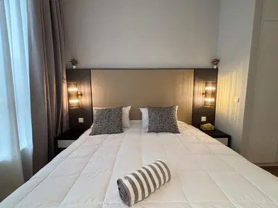 a bedroom with a large white bed with two pillows at Pavilion Ceylon Hill Luxury suit Bukit Bintang by cupidhome in Kuala Lumpur