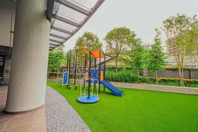 a playground in a park with green grass at The Atrium at Jalan Ampang by OKBnB- Modern Cozy 3 Bedroom Apartment 4 Mins to KLCC in Kuala Lumpur