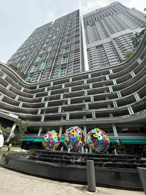 three donuts in front of a tall building at Trion KL Residence By CozyNest in Kuala Lumpur