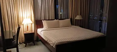a bed in a hotel room with a window at Times Square apartment klcc in Kuala Lumpur