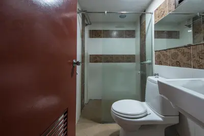 a bathroom with a toilet and a sink and a shower at Hotel Grand Orchard in Kuala Lumpur