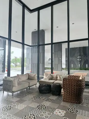 a living room with couches and large windows at Netflix - City View Pano Studio with Skypool, Free parking and 5 mins to MRT in Kuala Lumpur