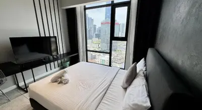 a bedroom with a bed with a large window at Bukit Bintang in Kuala Lumpur