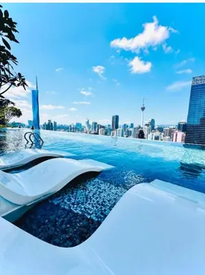 a swimming pool with a city in the background at Bukit Bintang in Kuala Lumpur