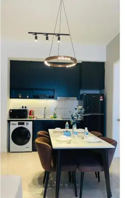 a kitchen with a table with chairs and aendant light at Bukit Bintang in Kuala Lumpur