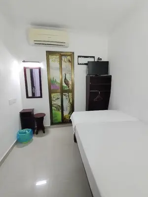 a white room with a bed and a mirror at J Hotel Masjid India KL in Kuala Lumpur