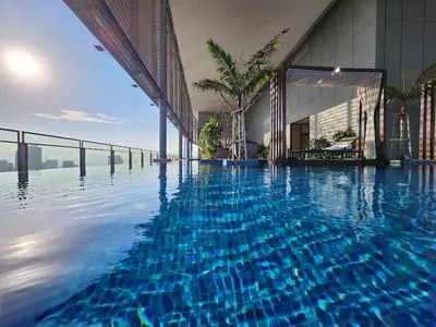 a swimming pool with blue water in front of a building at Pavilion Ceylon Hill Luxury apartment Bukit Bintang by cupidhome in Kuala Lumpur